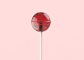 Red medicated lollipop on a soft pink background