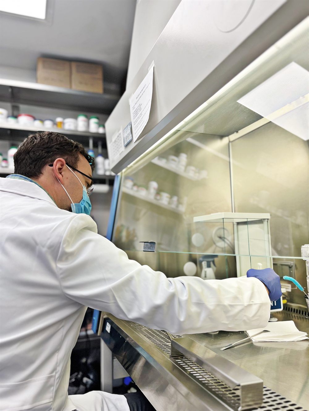 Non-sterile compounding technician preparing a custom medication